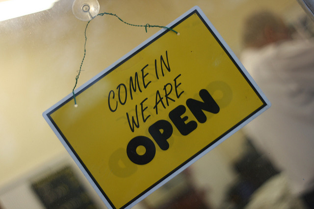 Image of a "Come in we are open" sign.